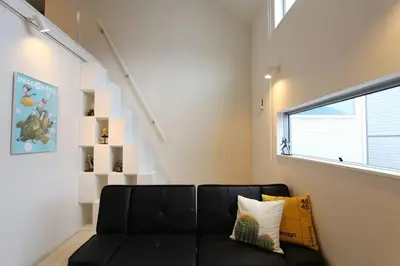 a black couch in a living room with a window at Shibuya Stay Tokyo A203 in Tokyo