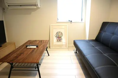 a living room with a couch and a table at Shibuya Stay Tokyo B102 in Tokyo