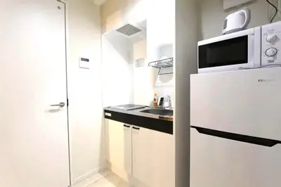 a small kitchen with a sink and a microwave at Shibuya Stay Tokyo B102 in Tokyo