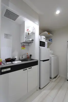 a white kitchen with a sink and a refrigerator at Shibuya Stay Tokyo B204 in Tokyo