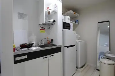 a small kitchen with a sink and a refrigerator at Shibuya Stay Tokyo B204 in Tokyo