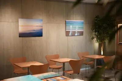 a restaurant with tables and chairs and paintings on the wall at Tokyu Stay Shibuya in Tokyo