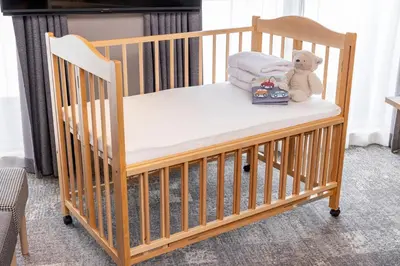 a crib with a teddy bear sitting on it at Tokyu Stay Shibuya in Tokyo