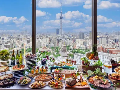 a buffet of food with a view of a city at Asakusa View Hotel in Tokyo
