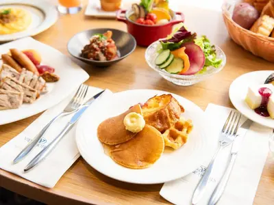 a table with plates of breakfast food on it at Asakusa View Hotel in Tokyo