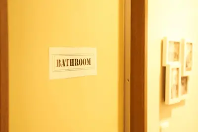 a sign on a door with the word bathroom at Garden Otsuka in Tokyo