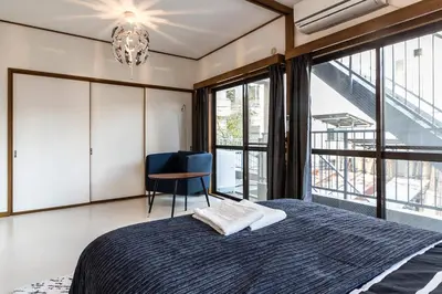 a bedroom with a bed and a chandelier at Ikebukuro Yamase Building #GR1 in Tokyo