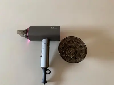 a hair dryer and a shield on a wall at Ikebukuro Yamase Building #GR1 in Tokyo