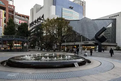 a fountain in the middle of a city with buildings at Ikebukuro Yamase Building #GR1 in Tokyo
