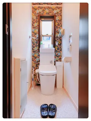 a bathroom with a toilet and a window at Hao Bros. Home in Tokyo