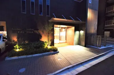 a building with a lit up door at night at Residence Condominium KALAHAAI in Tokyo