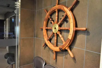 a wooden steering wheel on the wall of a bathroom at Residence Condominium KALAHAAI in Tokyo