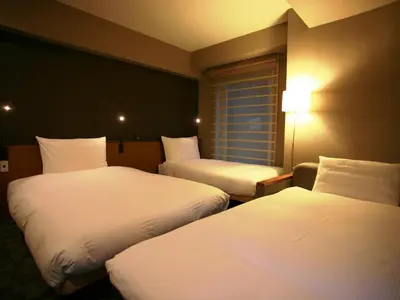 a hotel room with two beds and a window at Agora Place Tokyo Asakusa in Tokyo