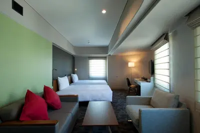 a hotel room with a bed and a couch at Agora Place Tokyo Asakusa in Tokyo