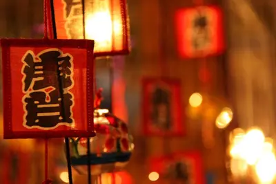 a group of red lanterns are hanging in a store at Agora Place Tokyo Asakusa in Tokyo