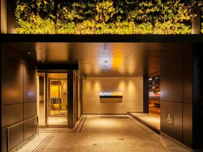 a hallway leading to a building with lights at Super Hotel Tokyo Hamamatsucho in Tokyo