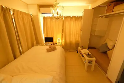 a bedroom with a bed and a laptop on a desk at COCO Nakameguro 201 in Tokyo