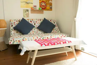 a living room with a couch and a table at Spring Apartment Shinjuku in Tokyo