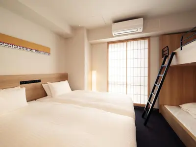 a bedroom with two beds and a ladder at MIMARU Tokyo Hatchobori in Tokyo