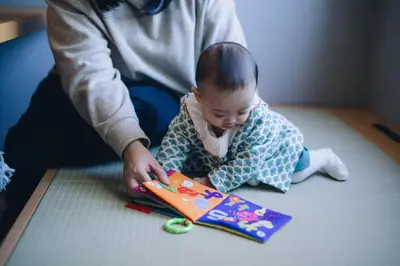 a baby sitting on the floor playing with a toy at MIMARU Tokyo Hatchobori in Tokyo