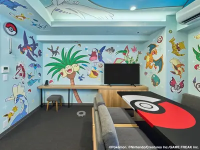 a room with a desk with a superhero mural on the wall at MIMARU Tokyo Hatchobori in Tokyo