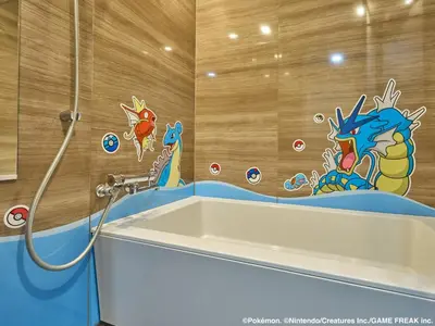 a bathroom with a bath tub with a dragon mural on the wall at MIMARU Tokyo Hatchobori in Tokyo