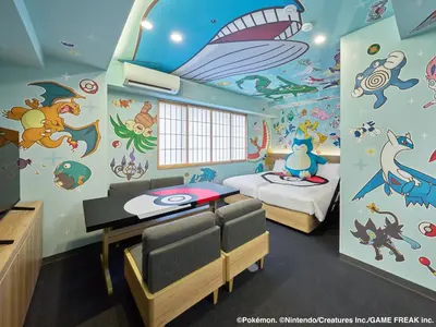 a room with two beds and a wall covered in stickers at MIMARU Tokyo Hatchobori in Tokyo