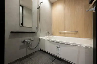 a bathroom with a bath tub and a sink at Richmond Hotel Asakusa in Tokyo