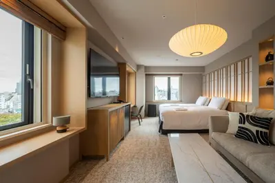 a hotel room with a bed and a couch at Richmond Hotel Asakusa in Tokyo