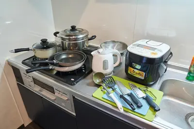 a kitchen counter with a stove with pots and pans at Asakusa Eight -Tokyo Condominium Hotel- in Tokyo