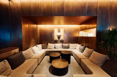 a living room with a couch and two tables at Hamacho Hotel Tokyo in Tokyo
