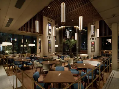 a restaurant with tables and chairs and windows at Hamacho Hotel Tokyo in Tokyo