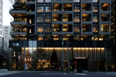 a tall building with lights on in a city at Hamacho Hotel Tokyo in Tokyo
