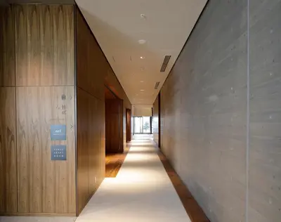 a hallway of a building with wooden walls at Hamacho Hotel Tokyo in Tokyo