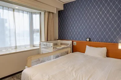a hotel room with a bed and a window at Richmond Hotel Tokyo Mejiro in Tokyo