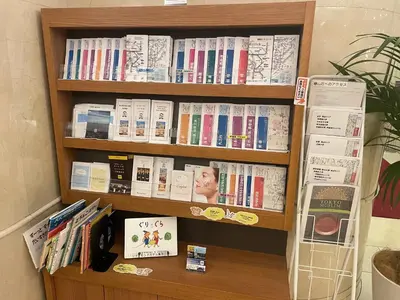 a book shelf with many books on it at Richmond Hotel Tokyo Mejiro in Tokyo