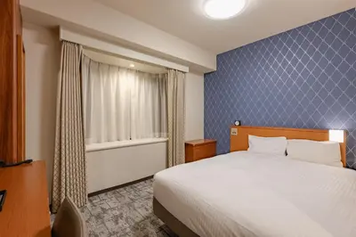 a hotel room with a bed and a window at Richmond Hotel Tokyo Mejiro in Tokyo