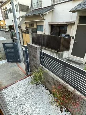 a fence in front of a house with a yard at Alo BnB 2 - Near NIPPORI, YANAKA GINZA, UENO, SENSOJI - Self check-in in Tokyo