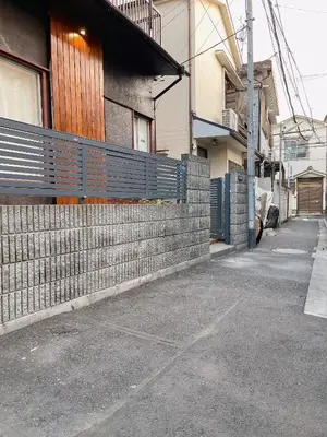 an empty street next to a building with a fence at Alo BnB 2 - Near NIPPORI, YANAKA GINZA, UENO, SENSOJI - Self check-in in Tokyo