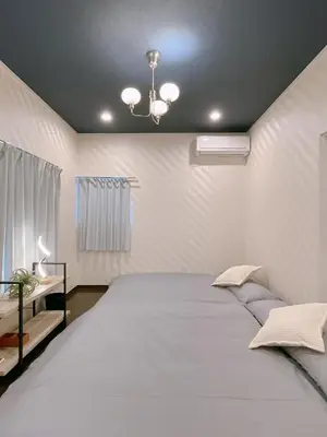 a bedroom with a large white bed with a ceiling at Alo BnB 2 - Near NIPPORI, YANAKA GINZA, UENO, SENSOJI - Self check-in in Tokyo