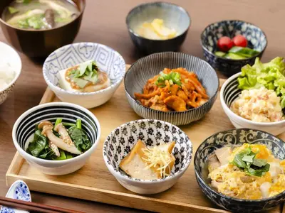 a group of bowls of food on a wooden table at Hotel Wing International Tokyo Akabane in Tokyo