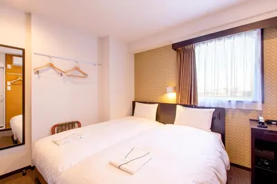 a hotel room with a bed and a window at Hotel Wing International Tokyo Akabane in Tokyo