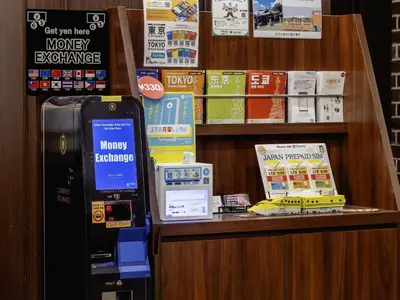 a money exchange machine in a store with a cash register at Hotel Wing International Tokyo Akabane in Tokyo