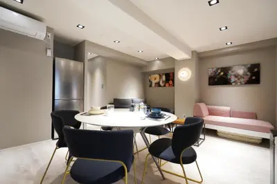 a room with a table and chairs and a couch at Real Life Kudanshita in Tokyo