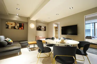 a living room with a table and chairs at Real Life Kudanshita in Tokyo