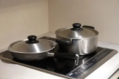 two pots sitting on top of a stove at Real Life Kudanshita in Tokyo