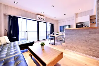 a living room with a couch and a table at Real Life Kudanshita in Tokyo