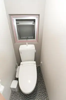 a small bathroom with a toilet with a window at bnb+ Asakusa Kuramae in Tokyo