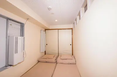 a room with two beds and a window at bnb+ Asakusa Kuramae in Tokyo