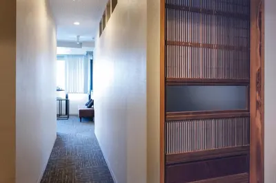 a hallway with wooden shelves in a room at bnb+ Asakusa Kuramae in Tokyo